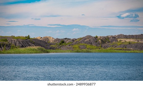 Tranquil lake, rocky shoreline, perfect for outdoor exploration and relaxation in a natural setting - Powered by Shutterstock