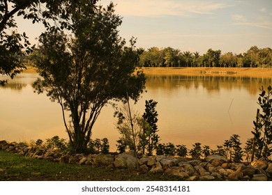 A tranquil lakeside park with lush greenery and calm water reflections with a serene environment highlights nature's beauty and is perfect for relaxing outdoors.
 - Powered by Shutterstock