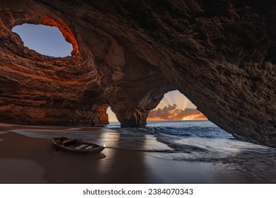 Tranquil landscape featuring an ocean Benagil Cave Algarve - old fishing boat in the benagil cave - Powered by Shutterstock