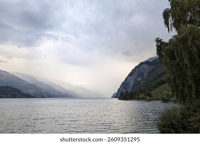 Tranquil Mountain Lake with Dramatic Cloudy Sky