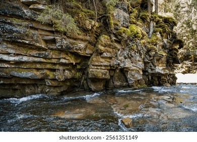 Tranquil Mountain Stream Flowing Over Moss-Covered Rocky Outcrop. - Powered by Shutterstock