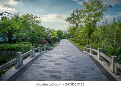 Tranquil Park Pathway under Blue Sky - Powered by Shutterstock