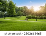 Tranquil Park Scene at Sunrise with Lush Greenery and Peaceful Pathway  