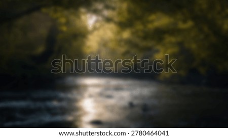 A tranquil river winds its way through a vibrant forest, bathed in the warm glow of sunlight filtering through the trees, creating a peaceful and picturesque scene.