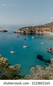 A Tranquil Scene Of Beautiful Landscape In Ibiza Overlooking Turquoise Waters And White Sand Beach. 