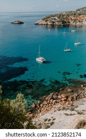 A Tranquil Scene Of Beautiful Landscape In Ibiza Overlooking Turquoise Waters And White Sand Beach. 