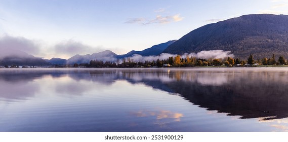 A tranquil scene of a misty morning with mountains and calm waters reflecting the landscape in Mission, British Columbia, Canada. - Powered by Shutterstock