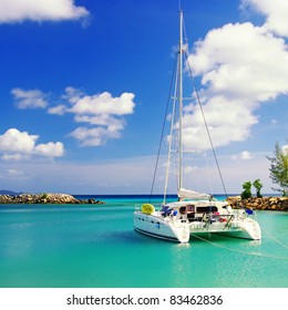tranquil scene in sunny morning on Seychelles with sailing boat