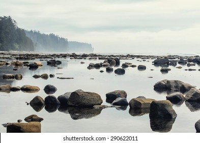 Tranquil sea water surface landscape with stone reflections on Pacific shore of Vancouver Island, BC - Powered by Shutterstock