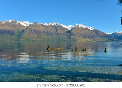 Tranquil Snow Capped Mountain Reflections On The Still Waters Of Lake Wakatipu At Meiklejohns Bay In Central Otago New Zealand 