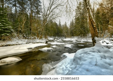 Tranquil Snowy Forest Stream Flows Through a Winter Landscape - Powered by Shutterstock