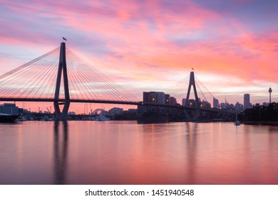 Tranquil sunrise over Anzac Bridge, Sydney Australia. Photo taken Blackwattle Bay park in Glebe. - Shutterstock ID 1451940548
