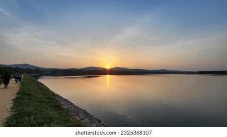 Tranquil Sunset over Calm Reservoir. Sunset over calm lake with reflective waters, peaceful beach scene with serene beauty. - Powered by Shutterstock