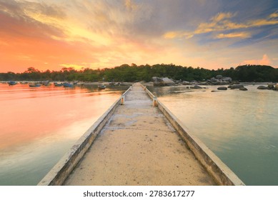 Tranquil sunset scene featuring a pathway leading to a serene beach with vibrant skies.