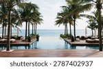 A tranquil tropical scene featuring a beachfront resort pool surrounded by palm trees.