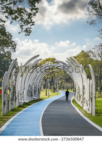 Tranquil Urban Park Path Featuring Unique Architectural Arches