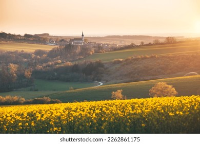 Tranquil view on of sunlit wavy fields of agricultural area. Location place of South Moravia region, Czech Republic, Europe. Photo wallpaper. Image of an ecological district. Beauty of world.