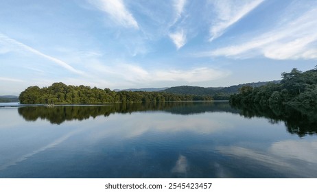 Tranquil view of Peechi Dam, Kerala, with lush greenery, calm waters, and serene blue skies—perfect for nature and travel themes. - Powered by Shutterstock