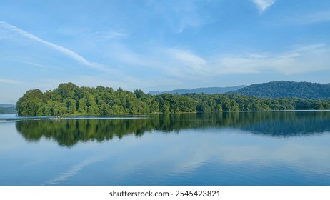 Tranquil view of Peechi Dam, Kerala, with lush greenery, calm waters, and serene blue skies—perfect for nature and travel themes. - Powered by Shutterstock