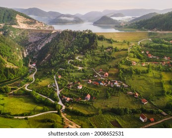 Tranquil View Of Remote Mountain Village With Lake In Misty Summer Morning. Nature Outdoors Travel Destination, National Park Tara, Zaovine Lake, Serbia 