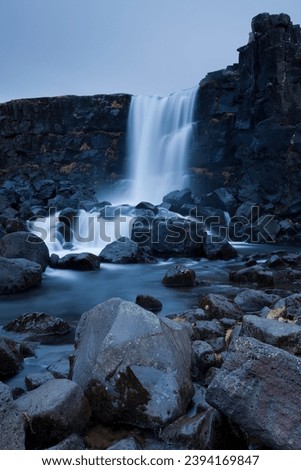 Tranquil view of Öxarárfoss waterfall in Thingvellir National Park in Iceland at dusk
