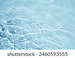 Tranquil Water Surface Texture. A serene, close-up view of light blue water with gentle ripples.