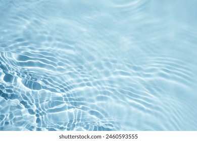 Tranquil Water Surface Texture. A serene, close-up view of light blue water with gentle ripples.