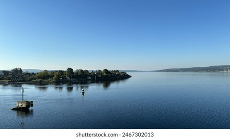 Tranquil Waterfront View with Clear Sky and Calm Waters - Ideal for Boating and Serene Living