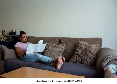 Trans Boy Reading A Book At Home