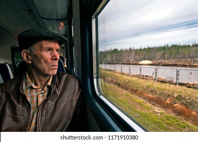 Trans Siberian Express, Siberia, Russia - March 20, 2018:  Old Russian Passenger Is Watching Outside From Trans Siberian Train In Siberia, Russia.