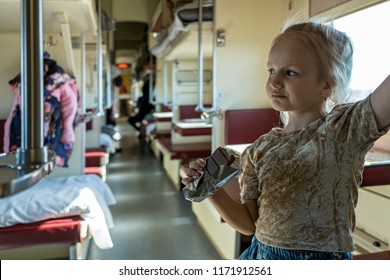 Trans Siberian Express, Siberia, Russia - March 20, 2018: Little Russan Girl Is Playing With Her Baby In Trans Siberian Ekspress. Siberia, Russia.