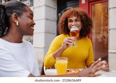 Trans woman drinking a craft beer with her friend. Inclusive friendship. - Powered by Shutterstock