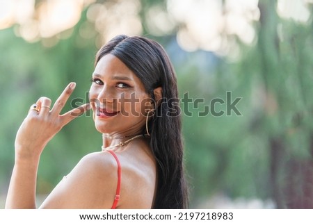 Trans woman gesturing victory with the fingers outdoors Foto stock © 