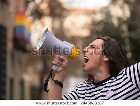 Trans woman is holding a megaphone and yelling to protest for homosexual social discrimination