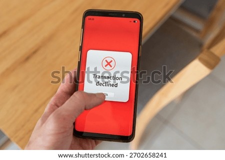 Transaction declined by payment processor message on phone screen.