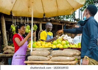 Transaction In A Market Place While A Customer Wears A Face Mask To Prevent Himself For The Outbreak In The Society .