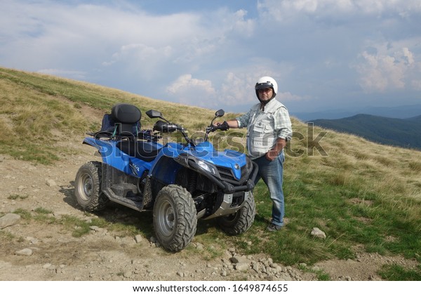 Transcarpathia, Ukraine - August 27, 2019: CF\
Moto CFORCE 450 ATV blue 4x4. Quad motorbike. Extreme sport motion,\
adventure, tourist\
attraction.