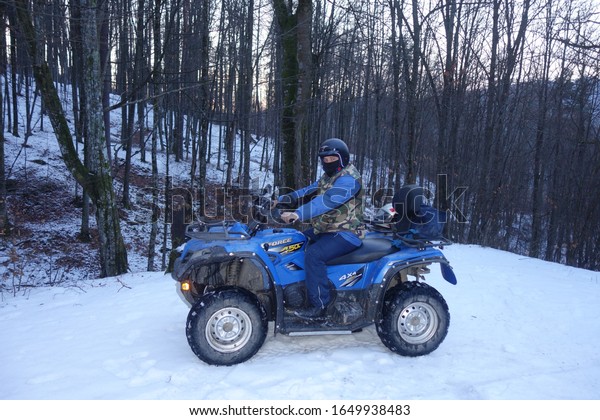 Transcarpathia, Ukraine - February 15, 2020:\
CF Moto CFORCE 450 ATV blue 4x4. Quad motorbike. Extreme sport\
motion, adventure, tourist\
attraction.