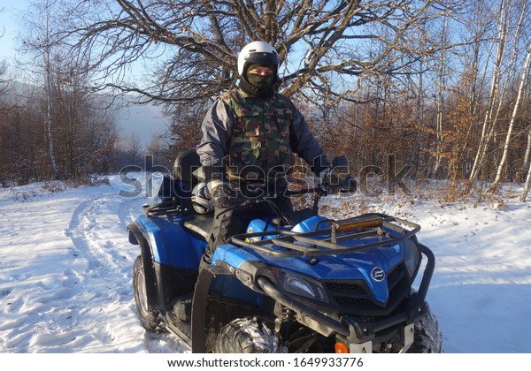 Transcarpathia, Ukraine - January 7, 2020: CF\
Moto CFORCE 450 ATV blue 4x4. Quad motorbike. Extreme sport motion,\
adventure, tourist\
attraction.