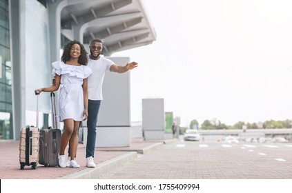 Transfer From Airport. Young African Couple Catching Taxi On Parking Near Terminal, Copy Space - Powered by Shutterstock