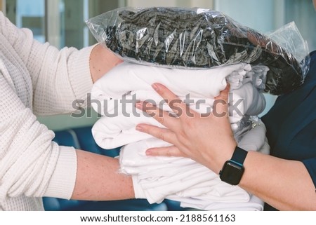 Transfer of clothes from hand to hand