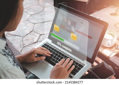 Transfer files data system relocation concept, Person hand using laptop computer waiting for transfer file process with loading bar icon on virtual screen.	 - Shutterstock ID 2145384277