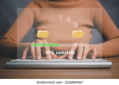 Transfer files data system relocation concept, Person hand using laptop computer waiting for transfer file process with loading bar icon on virtual screen.