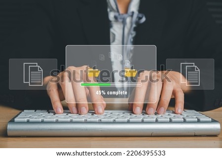 Transfer files data system relocation concept, Person hand typing keyboard computer waiting for transfer file process with loading bar icon on virtual screen.