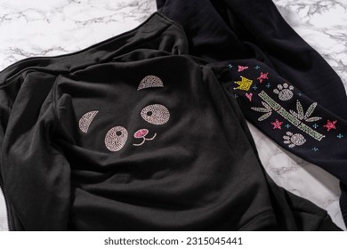 Transfering rhinestone pattern into the figure skating practice clothes with an iron.