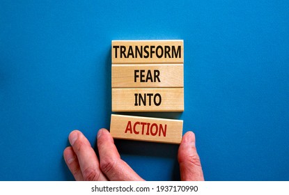 Transform fear into action symbol. Businessman holds wooden blocks with words 'Transform fear into action'. Beautiful blue background, copy space. Business, transform fear into action concept. - Shutterstock ID 1937170990