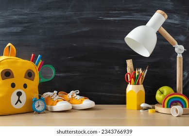 Transform your online education materials with a side view capture of a white desk, backpack and school supplies on blackboard isolated background, designed for text or advertising incorporation - Powered by Shutterstock