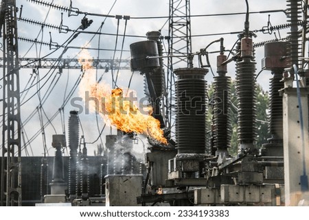 Transformer explosion in power plant. High-voltage insulator on fire. Electric explosion.