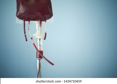 Transfusion Of Blood, Bag With Red Blood Cells On Stand. Blue Background With Copy Space