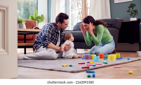 Transgender Family With Baby Playing Game With Colourful Toys In Lounge At Home - Powered by Shutterstock